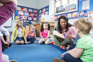 Practitioner engaging with children whiel reading a story