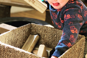 child at granby nursery playing with wooden blocks