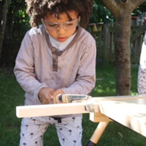 child doing woodwork
