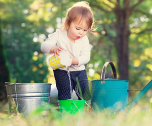 child playing with water using different containers