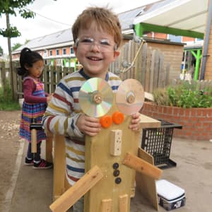 child with woodwork model