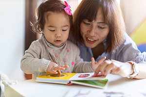 Practitioner and child sharing book