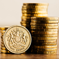 pound GBP coin and gold money on the desk