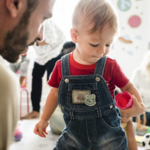 parent partnerships: father playing with child at nursery