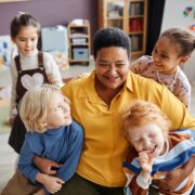 attachment in early years - practitioner hugging children