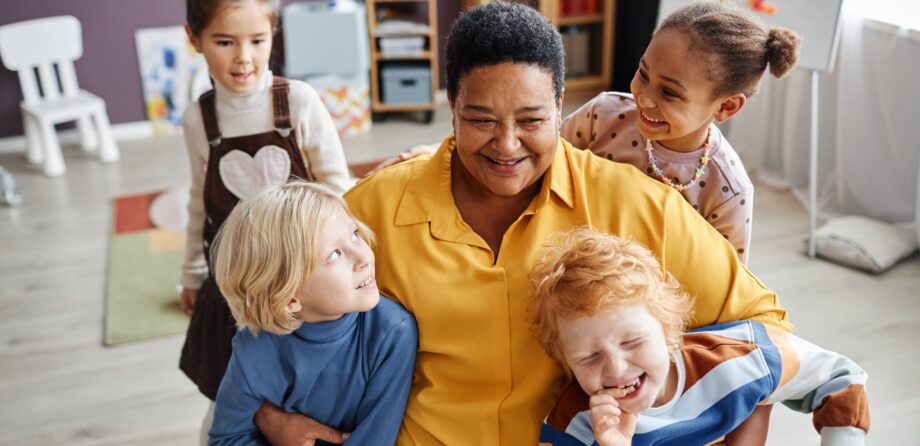 attachment in early years - practitioner hugging children