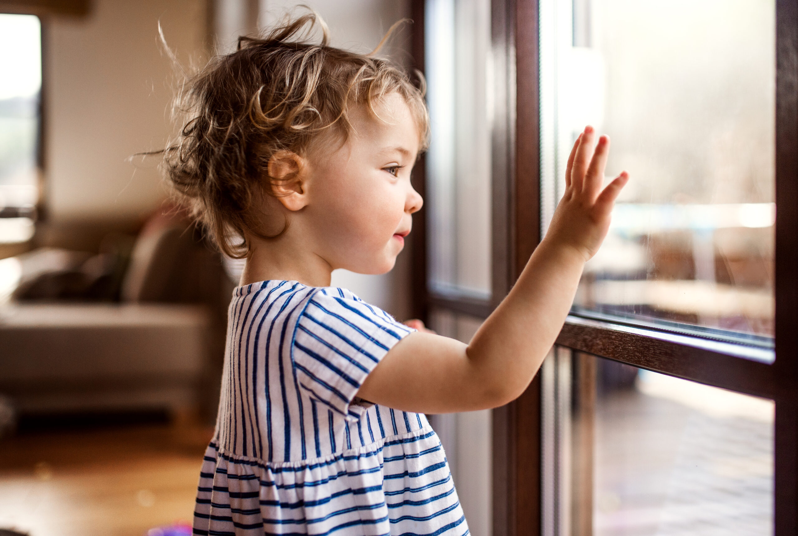 Little girl looking out of window