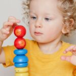 Maths Champions: child balancing wooden toys