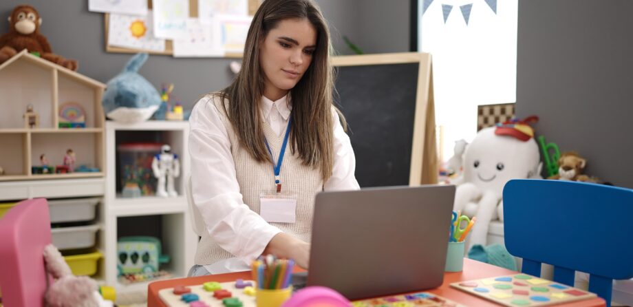 Marketing your nursery: Nursery teacher on laptop