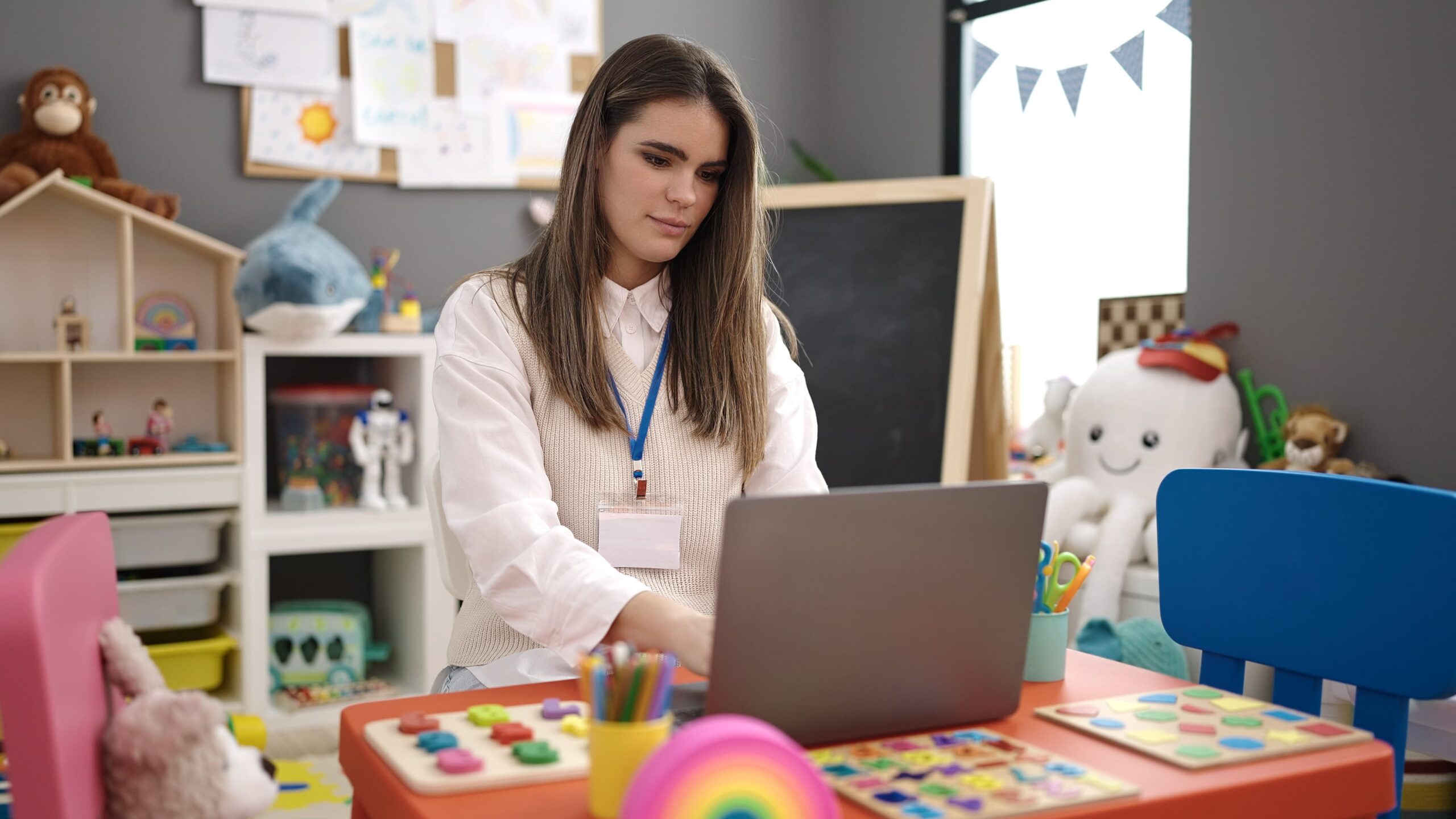 Marketing your nursery: Nursery teacher on laptop