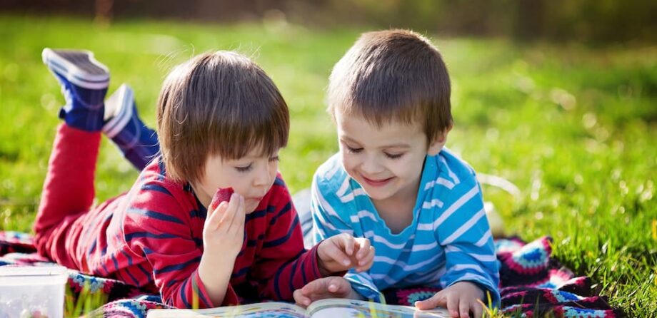 Charging parents guidance: children reading book together