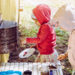 EYFS in the moment planning in nurseries - children in mud kitchen