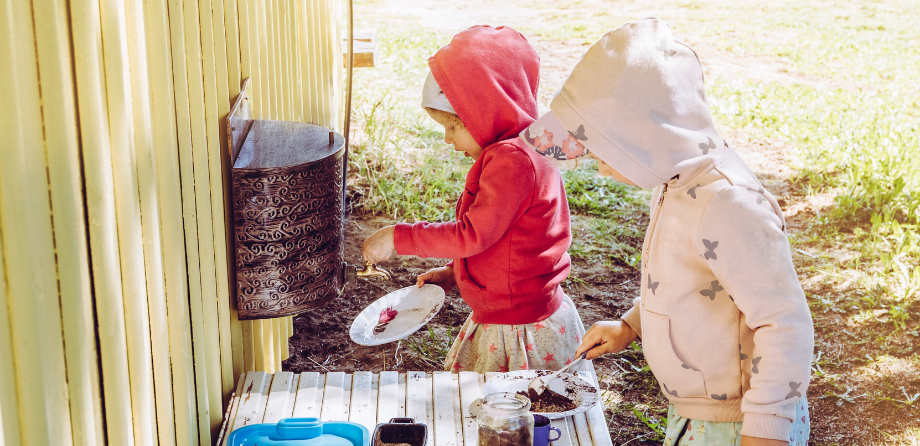 EYFS in the moment planning in nurseries - children in mud kitchen