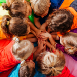 effective teaching - children laid in circle at nursery playing
